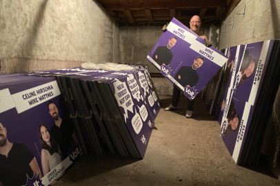 Viele Volt Plakate. In der Mitte ein Mann mit einem Direktkandidaten-Plakat in der Hand.