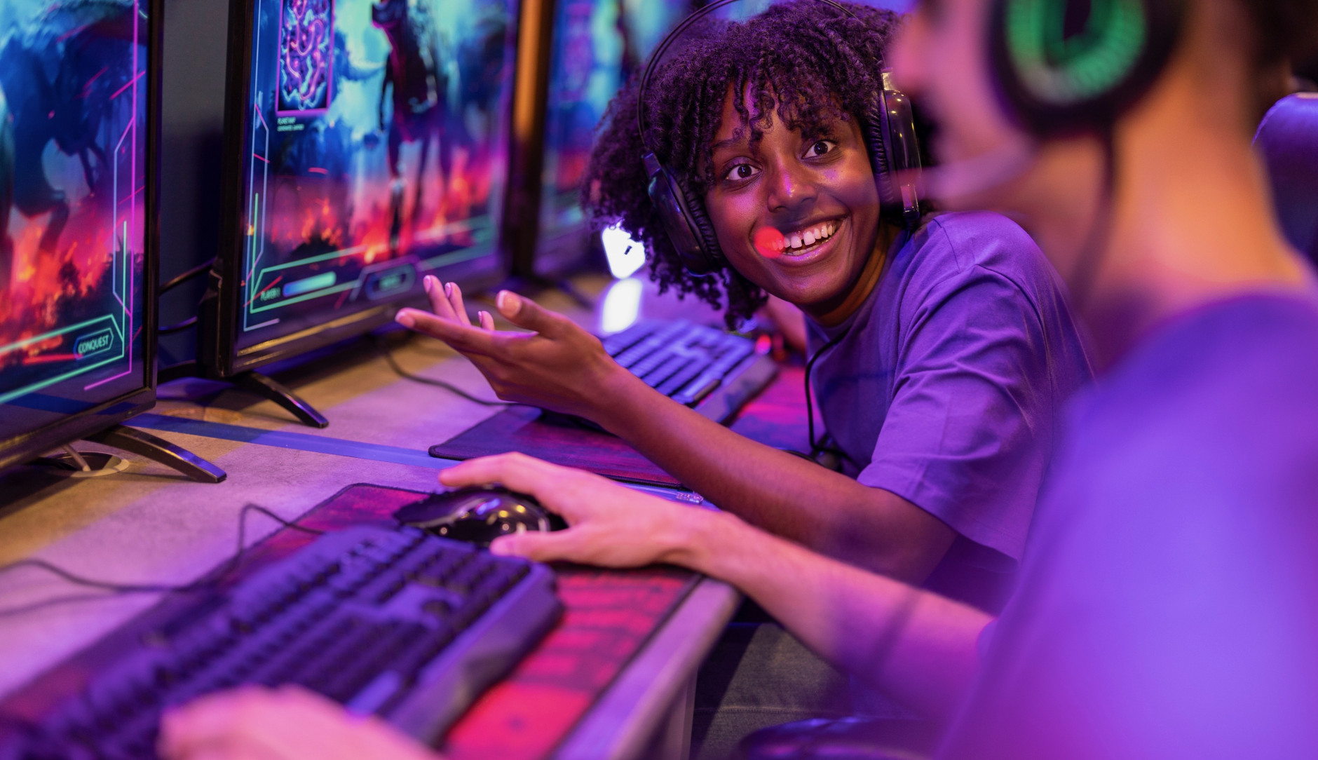 Person playing games in front of several computer screens