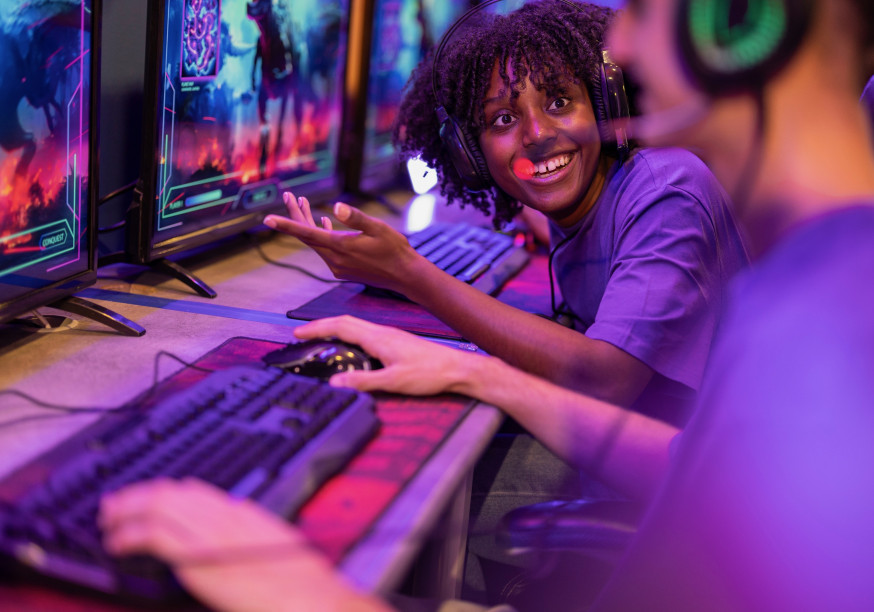 Person playing games in front of several computer screens