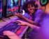 Person playing games in front of several computer screens