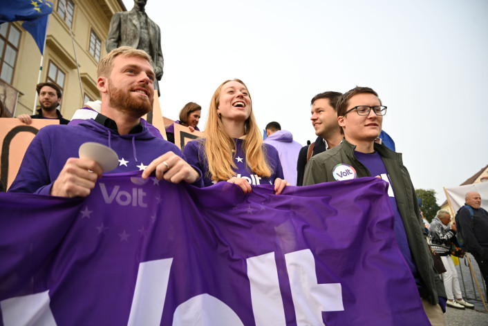 Volt at a public event holding a flag