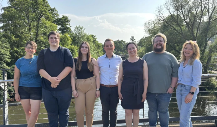 Die Menschen des Landesvorstands Hessen stehen auf einer Brücke über einem Fluss.