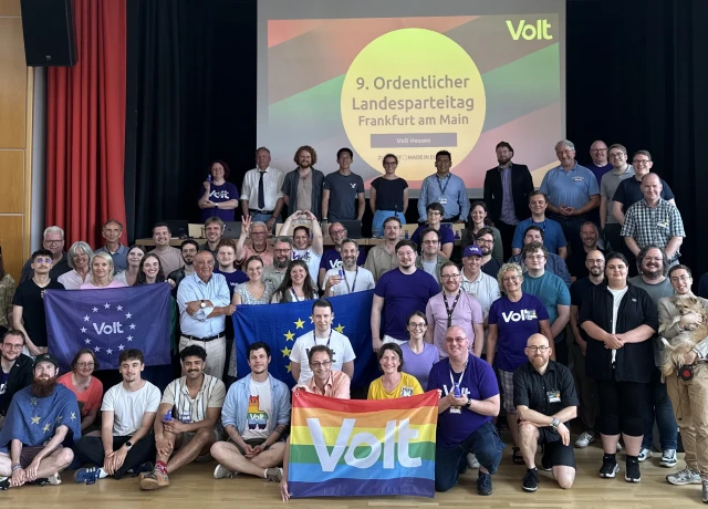Ein Gruppenfoto der Mitglieder von Volt Hessen mit Europa- und Voltfahnen